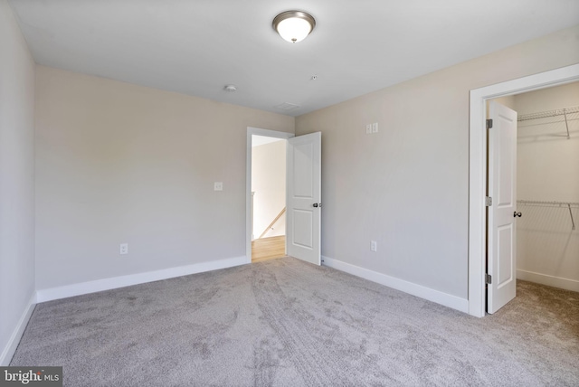 7108 River Drive Rd, Sparrows Point, MD 21219 - unfurnished bedroom featuring a walk in closet, carpet, and a closet