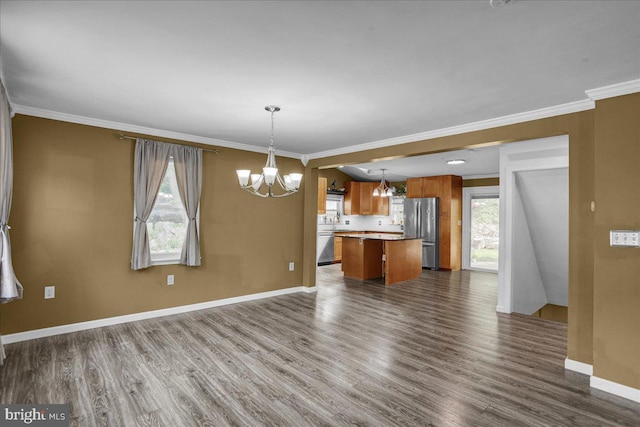3629 Chestnut St, Reading, PA 19605 - kitchen featuring freestanding refrigerator, a chandelier, open floor plan, ornamental molding, and dark wood-style flooring