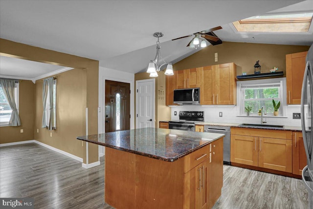 3629 Chestnut St, Reading, PA 19605 - kitchen featuring stainless steel appliances, light wood-type flooring, decorative backsplash, and vaulted ceiling