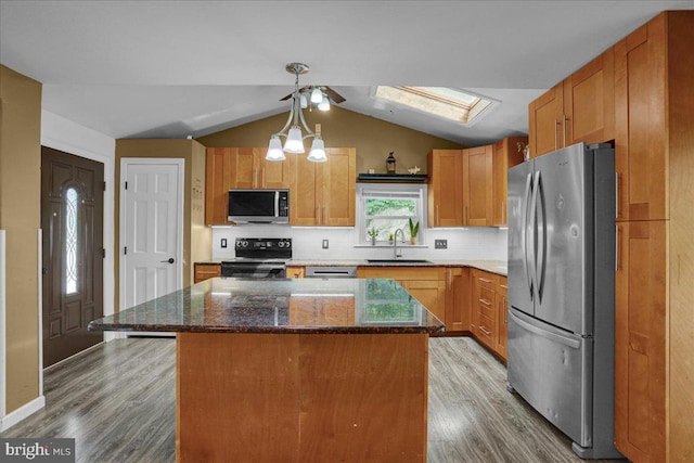 3629 Chestnut St, Reading, PA 19605 - kitchen with appliances with stainless steel finishes, a skylight, light wood finished floors, vaulted ceiling, and backsplash