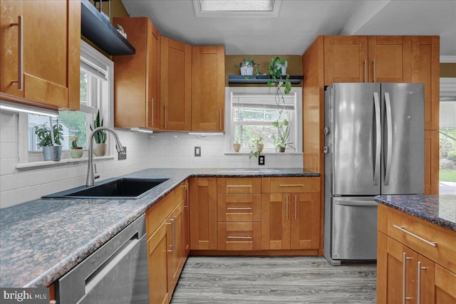 3629 Chestnut St, Reading, PA 19605 - kitchen with appliances with stainless steel finishes, light wood-type flooring, tasteful backsplash, and healthy amount of natural light