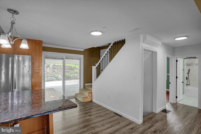 3629 Chestnut St, Reading, PA 19605 - kitchen featuring freestanding refrigerator, dark wood-style floors, brown cabinets, a chandelier, and crown molding