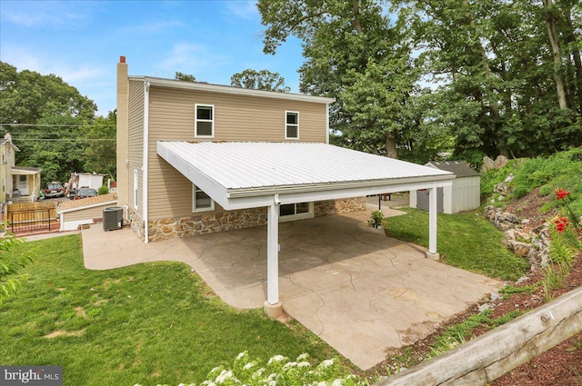 3629 Chestnut St, Reading, PA 19605 - back of property with a chimney, a lawn, a carport, a patio, and a metal roof
