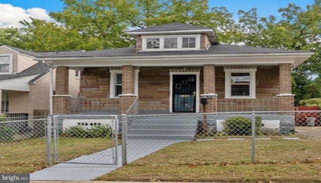 1113 Booth Ln, Capitol Heights, MD 20743 - view of front of home with covered porch, a fenced front yard, a gate, and brick siding