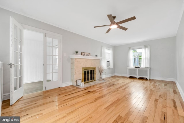 824 Lindale Ave, Drexel Hill, PA 19026 - unfurnished living room featuring radiator heating unit, hardwood / wood-style flooring, a ceiling fan, a fireplace with flush hearth, and cooling unit