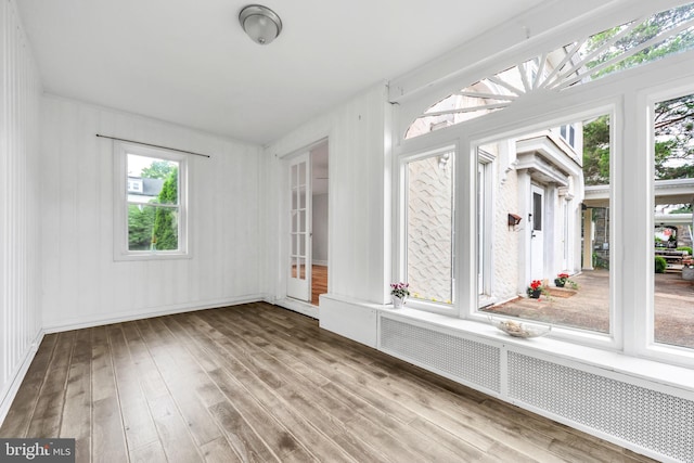 824 Lindale Ave, Drexel Hill, PA 19026 - unfurnished sunroom with radiator, wood finished floors, plenty of natural light, and a deck
