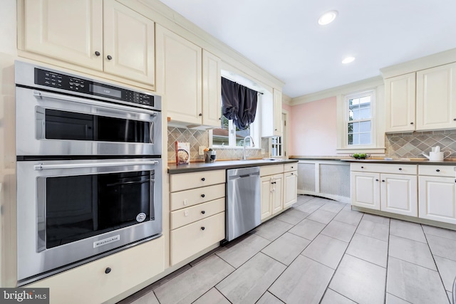 824 Lindale Ave, Drexel Hill, PA 19026 - kitchen with stainless steel appliances, decorative backsplash, recessed lighting, light tile patterned flooring, and dark countertops