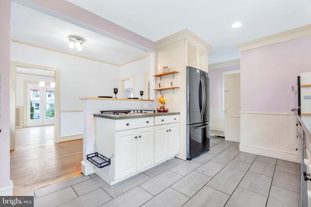 824 Lindale Ave, Drexel Hill, PA 19026 - kitchen featuring freestanding refrigerator, a wainscoted wall, crown molding, white cabinetry, and a peninsula