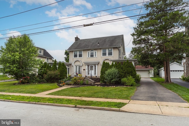 824 Lindale Ave, Drexel Hill, PA 19026 - colonial-style house featuring a detached garage, a front yard, a chimney, and an outbuilding