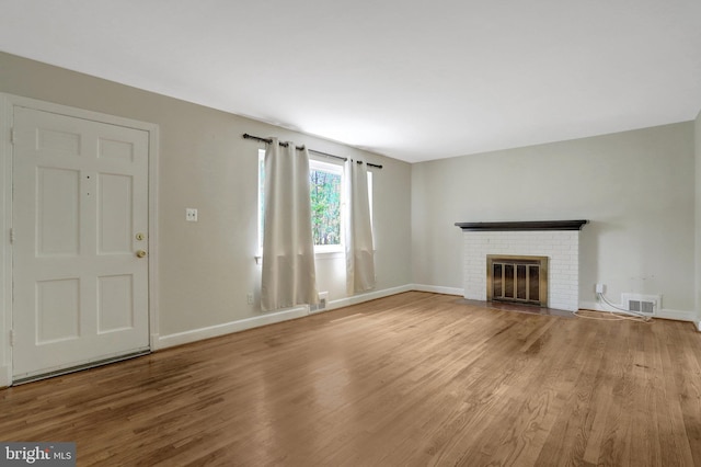 6005 Frederick St, Springfield, VA 22150 - unfurnished living room featuring wood finished floors and a fireplace