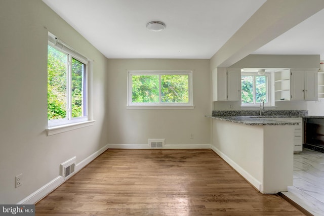 6005 Frederick St, Springfield, VA 22150 - kitchen featuring healthy amount of natural light, white cabinets, open shelves, and stone counters