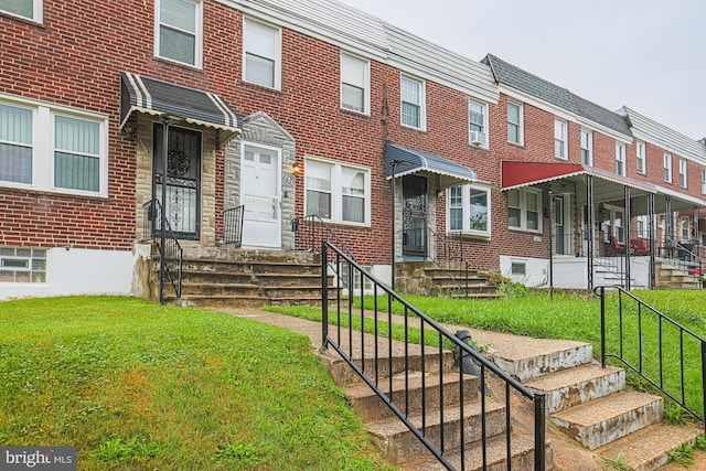 3635 Lyndale Ave, Baltimore, MD 21213 - multi unit property featuring a front yard and brick siding