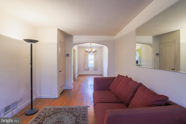 3635 Lyndale Ave, Baltimore, MD 21213 - living room featuring arched walkways, a chandelier, and wood-type flooring