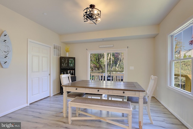 8207 Elm Ln, Chesapeake Beach, MD 20732 - dining area with light wood-style flooring and a chandelier