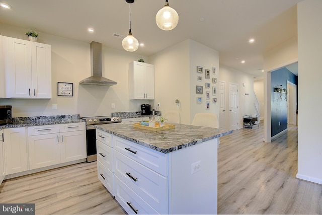 8207 Elm Ln, Chesapeake Beach, MD 20732 - kitchen with wall chimney exhaust hood, appliances with stainless steel finishes, dark stone countertops, light wood-style floors, and recessed lighting