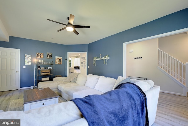 8207 Elm Ln, Chesapeake Beach, MD 20732 - living room featuring light wood finished floors, a ceiling fan, and stairway