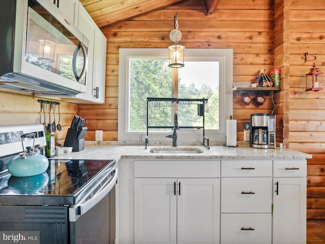 37AND41 Headwaters Rd, Chester Gap, VA 22623 - kitchen with stainless steel appliances, log walls, white cabinets, light stone countertops, and vaulted ceiling