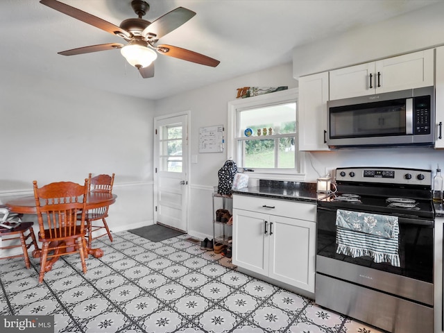37AND41 Headwaters Rd, Chester Gap, VA 22623 - kitchen featuring stainless steel appliances, white cabinetry, dark countertops, ceiling fan, and light floors
