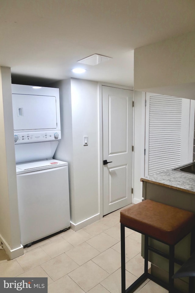 652 E Raymond St, Philadelphia, PA 19120 - laundry area featuring estacked washer and dryer and light tile patterned floors
