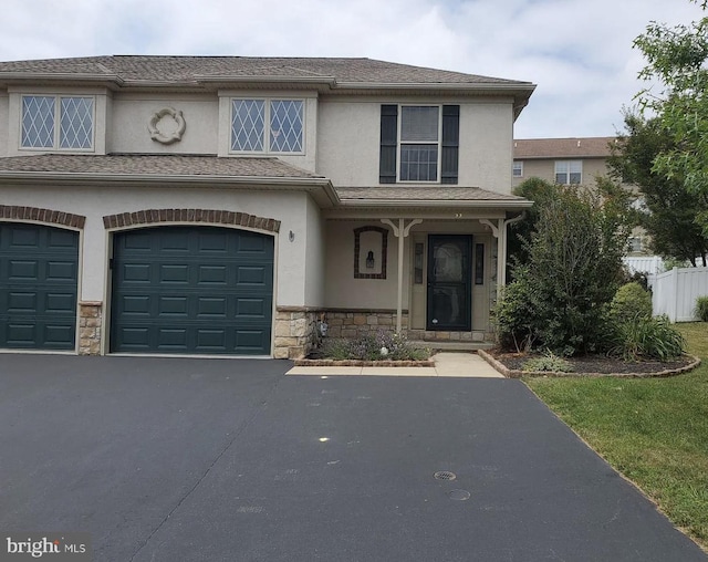 53 Hawk Ln, Ephrata, PA 17522 - view of property with stucco siding, stone siding, a garage, and asphalt driveway