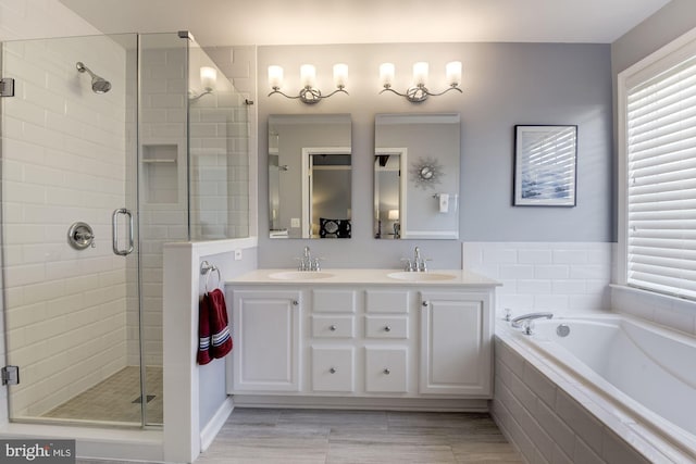 6362 Levtov Lndg, Alexandria, VA 22312 - full bathroom with a stall shower, healthy amount of natural light, a garden tub, and double vanity