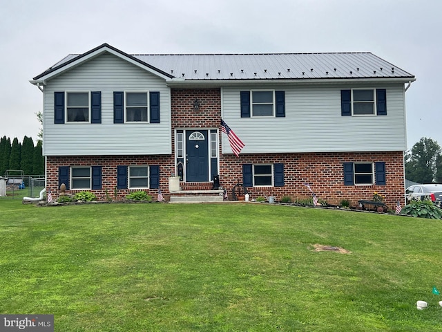 10474 Mapleton Rd, Shippensburg, PA 17257 - bi-level home featuring brick siding, a front lawn, and a metal roof