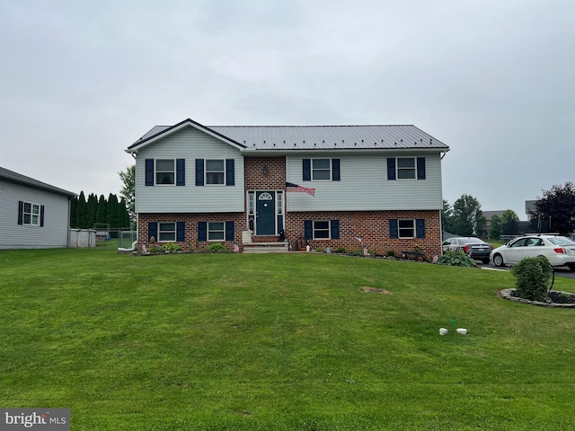 10474 Mapleton Rd, Shippensburg, PA 17257 - split foyer home featuring brick siding, a front lawn, and a metal roof