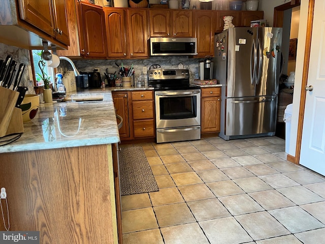 10474 Mapleton Rd, Shippensburg, PA 17257 - kitchen featuring appliances with stainless steel finishes, decorative backsplash, light tile patterned floors, light countertops, and brown cabinets