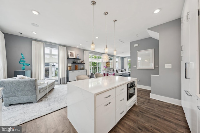 11336 Emerald Park Rd, Potomac, MD 20854 - kitchen featuring open floor plan, white cabinets, dark wood-type flooring, hanging light fixtures, and light countertops