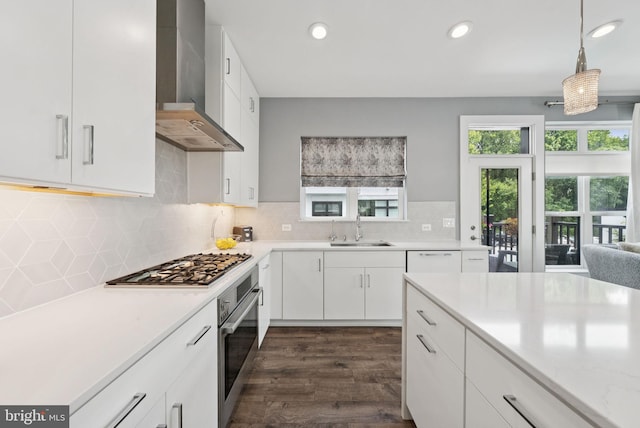 11336 Emerald Park Rd, Potomac, MD 20854 - kitchen with wall chimney range hood, stainless steel appliances, light countertops, dark wood finished floors, and recessed lighting