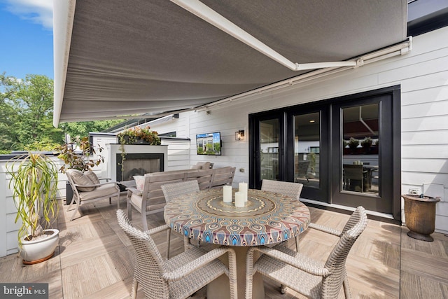 11336 Emerald Park Rd, Potomac, MD 20854 - view of patio / terrace with outdoor dining space and exterior fireplace