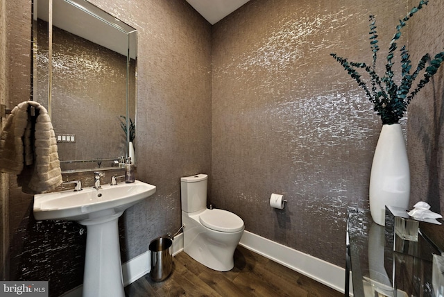 11336 Emerald Park Rd, Potomac, MD 20854 - half bathroom with wood finished floors and toilet