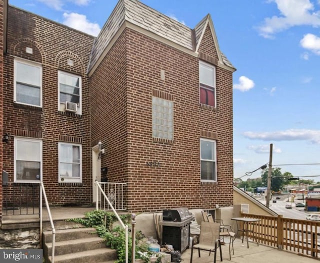 6858 Marshall Rd, Upper Darby, PA 19082 - back of property featuring brick siding and a patio area