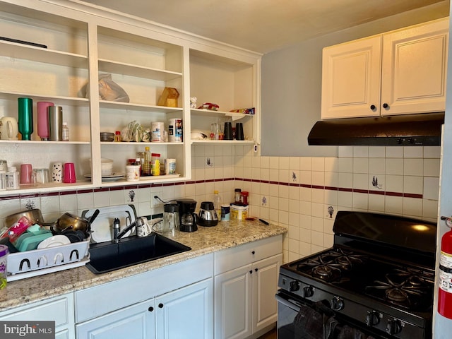 6858 Marshall Rd, Upper Darby, PA 19082 - kitchen with black gas range oven, under cabinet range hood, backsplash, white cabinets, and open shelves
