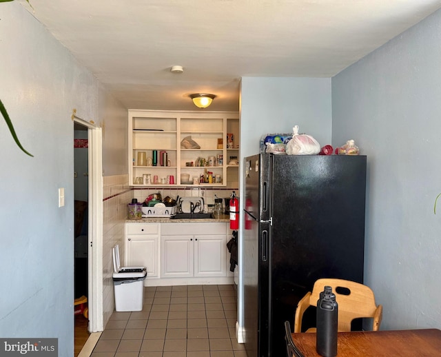 6858 Marshall Rd, Upper Darby, PA 19082 - kitchen featuring freestanding refrigerator, white cabinetry, tile patterned floors, light stone counters, and open shelves