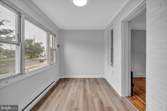 1528 Park Blvd, Camden, NJ 08103 - unfurnished room featuring baseboard heating, wood finished floors, ornamental molding, and a baseboard heating unit