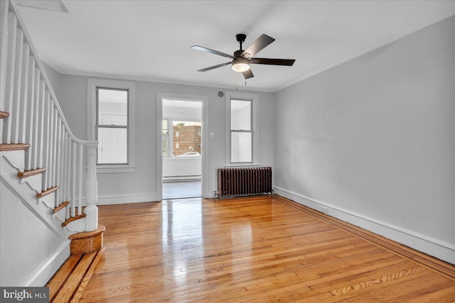 1528 Park Blvd, Camden, NJ 08103 - unfurnished room with radiator heating unit, stairs, light wood-style floors, ornamental molding, and a baseboard heating unit