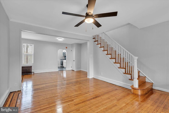 1528 Park Blvd, Camden, NJ 08103 - unfurnished living room with arched walkways, radiator heating unit, a ceiling fan, wood-type flooring, and ornamental molding