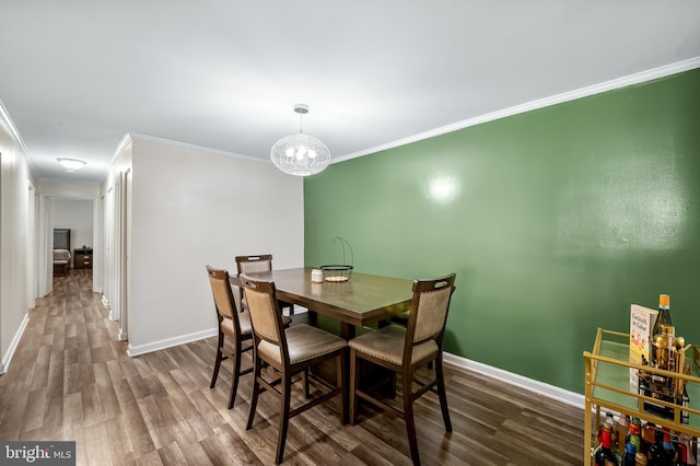 7702 Hanover Pkwy Unit 301, Greenbelt, MD 20770 - dining room with wood finished floors, crown molding, and a chandelier