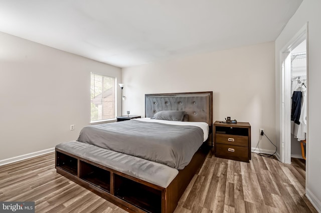 7702 Hanover Pkwy Unit 301, Greenbelt, MD 20770 - bedroom with wood finished floors, a spacious closet, and a closet