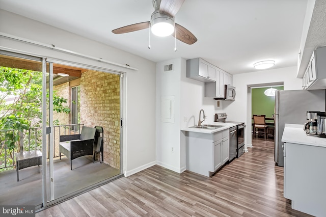 7702 Hanover Pkwy Unit 301, Greenbelt, MD 20770 - kitchen featuring appliances with stainless steel finishes, light countertops, light wood finished floors, and a ceiling fan