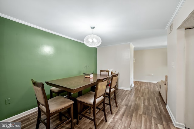 7702 Hanover Pkwy Unit 301, Greenbelt, MD 20770 - dining area with ornamental molding and wood finished floors