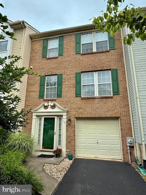 12 Barclay Dr, Hockessin, DE 19707 - multi unit property featuring a garage, driveway, and brick siding