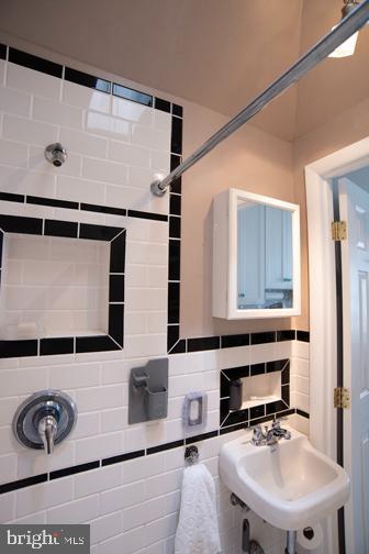 5600 Seaview Ave, Wildwood Crest, NJ 08260 - bathroom with a sink and tasteful backsplash