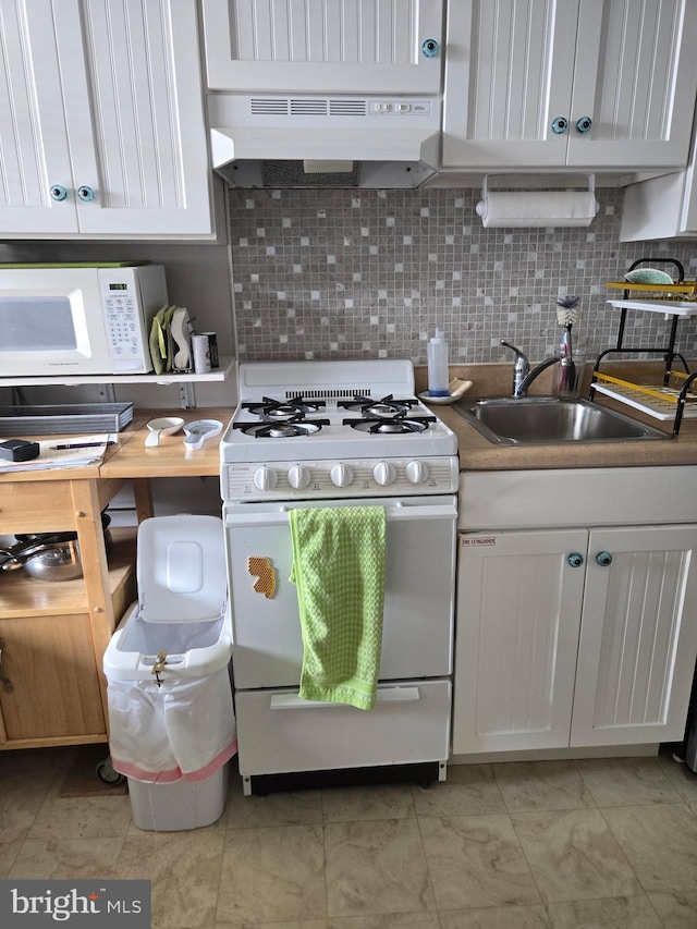5600 Seaview Ave, Wildwood Crest, NJ 08260 - kitchen with white appliances, under cabinet range hood, decorative backsplash, and white cabinetry