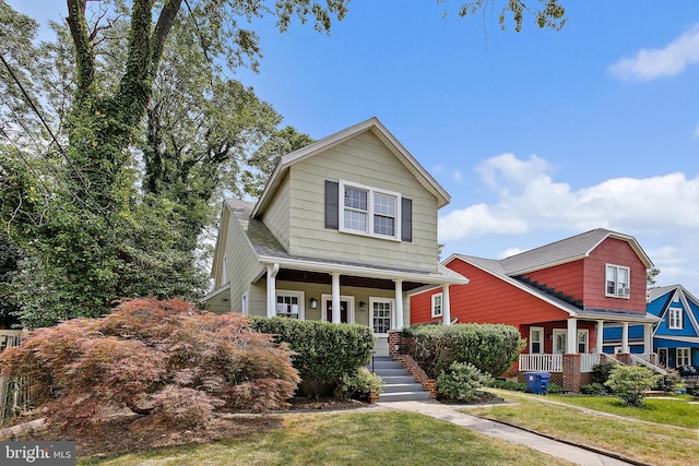 4713 Elsrode Ave, Baltimore, MD 21214 - view of front facade with a porch, a front yard, and stairs