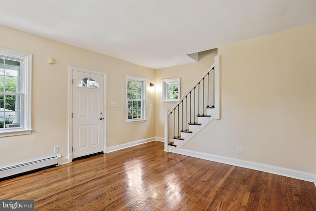 4713 Elsrode Ave, Baltimore, MD 21214 - foyer entrance with baseboard heating, healthy amount of natural light, stairs, and wood finished floors