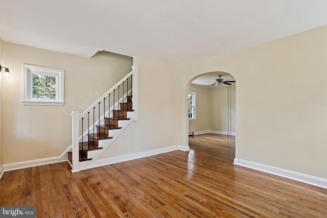 4713 Elsrode Ave, Baltimore, MD 21214 - interior space featuring stairs, wood finished floors, ceiling fan, and arched walkways