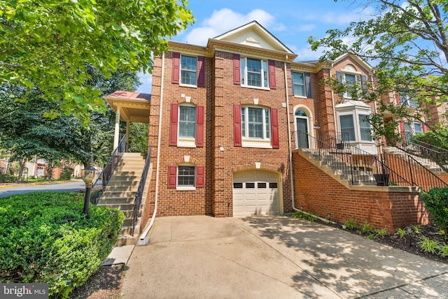 6498 Milva Ln, Springfield, VA 22150 - view of property featuring stairway, a garage, driveway, and brick siding