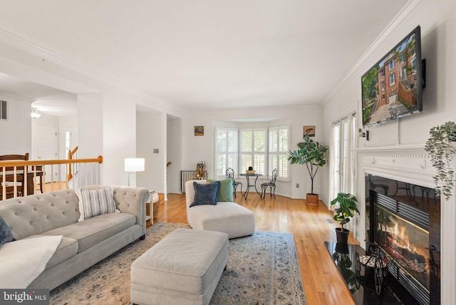 6498 Milva Ln, Springfield, VA 22150 - living area with light wood finished floors, ornamental molding, and a glass covered fireplace